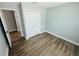 Bright bedroom with wood-look flooring, closet, and fresh paint at 412 Editha Cir, Sanford, FL 32771