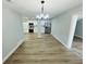 A dining room features wood-look floors and flows into the updated kitchen at 412 Editha Cir, Sanford, FL 32771