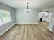 An open-concept dining room features wood-look floors and modern light fixture at 412 Editha Cir, Sanford, FL 32771