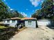 Charming single-story home with a well-maintained front yard and detached garage at 412 Editha Cir, Sanford, FL 32771