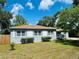 Exterior view of the home showing light-grey paint, white shutters, and a well maintained lawn at 412 Editha Cir, Sanford, FL 32771