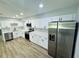 This kitchen features recessed lighting, white cabinets, and stainless appliances at 412 Editha Cir, Sanford, FL 32771