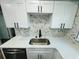 Updated kitchen boasts white cabinets, stainless sink and quartz counters at 412 Editha Cir, Sanford, FL 32771