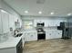 Renovated kitchen with white cabinets, quartz countertops, and stainless appliances at 412 Editha Cir, Sanford, FL 32771