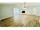 Open living area with wood look flooring and a painted brick fireplace at 412 Editha Cir, Sanford, FL 32771