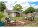 Large backyard with a shed, mature trees, and an outdoor seating area at 417 Carvell Dr, Winter Park, FL 32792