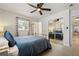 This bedroom features a ceiling fan, neutral walls and decor, a window, and a mirrored sliding door closet at 417 Carvell Dr, Winter Park, FL 32792