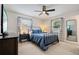 This bedroom features a ceiling fan, neutral walls and decor, two windows, and a black metal bed frame at 417 Carvell Dr, Winter Park, FL 32792