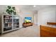 Brightly lit bedroom has ample floor space, a ceiling fan, a bookcase, and a television at 417 Carvell Dr, Winter Park, FL 32792