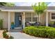 Charming front entrance with blue door, stylish seating, and beautifully landscaped walkway, with the house number 417 at 417 Carvell Dr, Winter Park, FL 32792