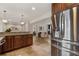 Kitchen with stainless steel refrigerator next to the bar looking into the living spaces at 417 Carvell Dr, Winter Park, FL 32792
