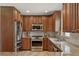 Modern kitchen with stainless steel appliances, granite counters, and tiled backsplash at 417 Carvell Dr, Winter Park, FL 32792