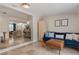 The living room features a blue couch, tile floors and seamlessly flows into other rooms at 417 Carvell Dr, Winter Park, FL 32792