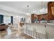Open living area flowing into a modern kitchen with stainless appliances, breakfast bar, and bright lighting at 417 Carvell Dr, Winter Park, FL 32792