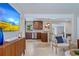 Open-concept living room with a view of the kitchen featuring stainless steel appliances and modern finishes at 417 Carvell Dr, Winter Park, FL 32792