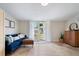 Bright living room with a blue sofa, French doors leading to the backyard, and travertine floors at 417 Carvell Dr, Winter Park, FL 32792