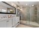 Updated bathroom with double vanity and glass-enclosed shower with grey tile and fixtures at 417 Carvell Dr, Winter Park, FL 32792