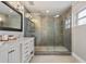 Renovated main bathroom with double vanity and glass-enclosed shower with grey tile at 417 Carvell Dr, Winter Park, FL 32792