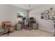 A well lit home office features dual monitors, a white chair, neutral walls and a window at 417 Carvell Dr, Winter Park, FL 32792