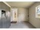 Enclosed back porch with a stainless steel fridge and a door to the backyard at 417 Carvell Dr, Winter Park, FL 32792
