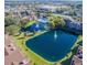 Aerial view of the community with a large pond, fountain, and surrounding buildings at 4225 Thornbriar Ln # 305, Orlando, FL 32822