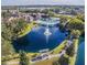 Scenic aerial view featuring a serene pond, fountain, and lush landscaping at 4225 Thornbriar Ln # 305, Orlando, FL 32822