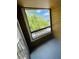 A balcony with a window featuring the view of lush greenery and neighborhood at 4225 Thornbriar Ln # 305, Orlando, FL 32822