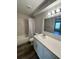 Bathroom with a shower/tub combo, updated vanity, and a large mirror at 4225 Thornbriar Ln # 305, Orlando, FL 32822