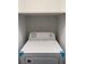 Laundry area featuring a white top load dryer and surrounding white shelving at 4225 Thornbriar Ln # 305, Orlando, FL 32822