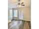 Bright living room with natural light from the large window and door. Wood look vinyl flooring at 4225 Thornbriar Ln # 305, Orlando, FL 32822