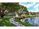 Picturesque pond with a fountain, green lawns, stone paths, and charming white gazebos at 4225 Thornbriar Ln # 305, Orlando, FL 32822