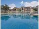 Inviting community pool with clear water, white fence and surrounding buildings at 4225 Thornbriar Ln # 305, Orlando, FL 32822