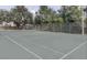 Spacious community tennis court surrounded by lush greenery, perfect for active residents at 4225 Thornbriar Ln # 305, Orlando, FL 32822