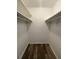 Ample storage space in the walk-in closet with shelves and a wood look vinyl floor at 4225 Thornbriar Ln # 305, Orlando, FL 32822