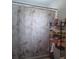 Bathroom view shows a shower and tub combination, a decorative shower curtain and a storage rack at 442 Fanfair Ave, Orlando, FL 32811