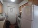 View of kitchen with a white refrigerator, door to outside and white countertops at 442 Fanfair Ave, Orlando, FL 32811