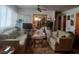 Comfortable living room featuring couches, patterned carpet, ceiling fan and window with sheer curtains at 442 Fanfair Ave, Orlando, FL 32811