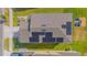 Aerial view shows solar panels on roof, lawn, and nearby playground at 4432 Seven Canyons Dr, Kissimmee, FL 34746