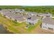 Aerial view of residential area and backyard with firepit, seating area, green grass and lake at 4432 Seven Canyons Dr, Kissimmee, FL 34746