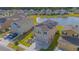Aerial view of home with solar panels, lush lawn, water views, and neighborhood at 4432 Seven Canyons Dr, Kissimmee, FL 34746