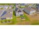 Backyard aerial view includes seating around a fire pit, lawn, trees, and nearby homes at 4432 Seven Canyons Dr, Kissimmee, FL 34746