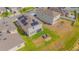 Aerial view of backyard featuring a fire pit, seating, green grass and lake at 4432 Seven Canyons Dr, Kissimmee, FL 34746
