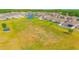 Aerial view of the community showing a pond, soccer field, homes and green space at 4432 Seven Canyons Dr, Kissimmee, FL 34746