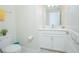Well-lit powder room with a toilet, vanity with modern fixtures, and stylish decor at 4432 Seven Canyons Dr, Kissimmee, FL 34746
