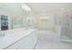 Bathroom with double vanity sinks, tub, walk-in shower and neutral color palette at 4432 Seven Canyons Dr, Kissimmee, FL 34746