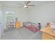 Childs bedroom featuring ample space, natural light, a ceiling fan, and playful decor elements at 4432 Seven Canyons Dr, Kissimmee, FL 34746