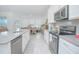 Bright kitchen with an island that seamlessly connects the kitchen to dining space at 4432 Seven Canyons Dr, Kissimmee, FL 34746