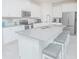Kitchen featuring a large center island with barstool seating and modern appliances at 4432 Seven Canyons Dr, Kissimmee, FL 34746