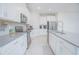 Contemporary kitchen with stainless steel appliances, grey countertops, and sleek cabinetry at 4432 Seven Canyons Dr, Kissimmee, FL 34746