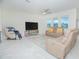 Bright living room features neutral tile flooring, ceiling fan and comfortable seating at 4432 Seven Canyons Dr, Kissimmee, FL 34746